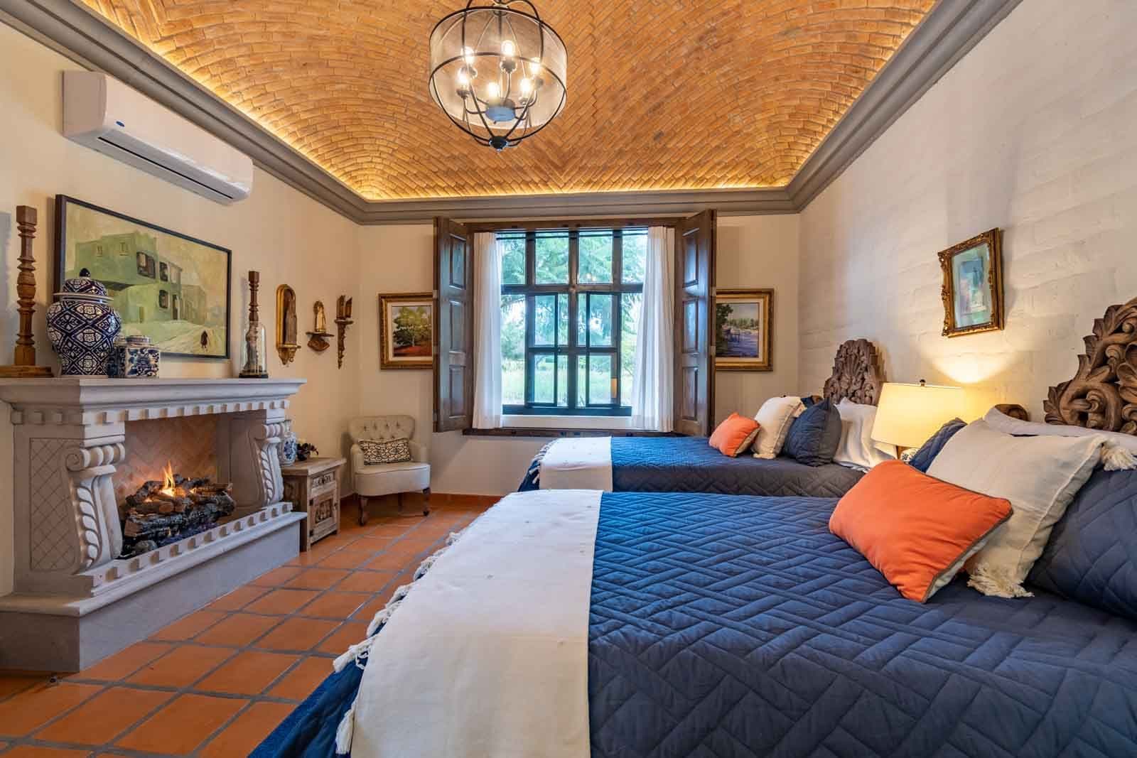 Casa Caterina — Las Campanas, San Miguel de Allende — photo 17 — elegant colonial suite, fireplace warmth glows