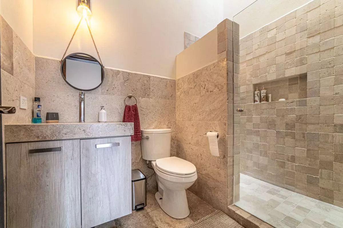 Casa Atardecer — Antigua Residencial, San Miguel de Allende — photo 16 — spa-inspired ensuite with natural stone finishes