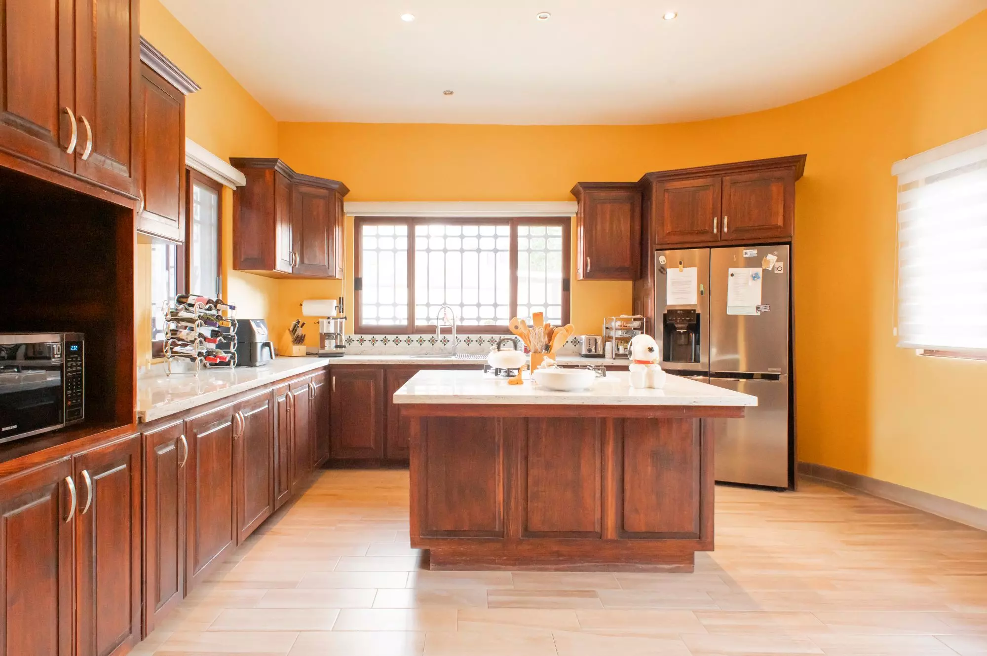 Casa Capricho Azul — El Capricho, San Miguel de Allende — photo 7 — radiant kitchen with rich wood cabinetry