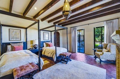 Casa Santuario — Balcones, San Miguel de Allende — photo 13 — elegant dual bedroom suite, rustic beams