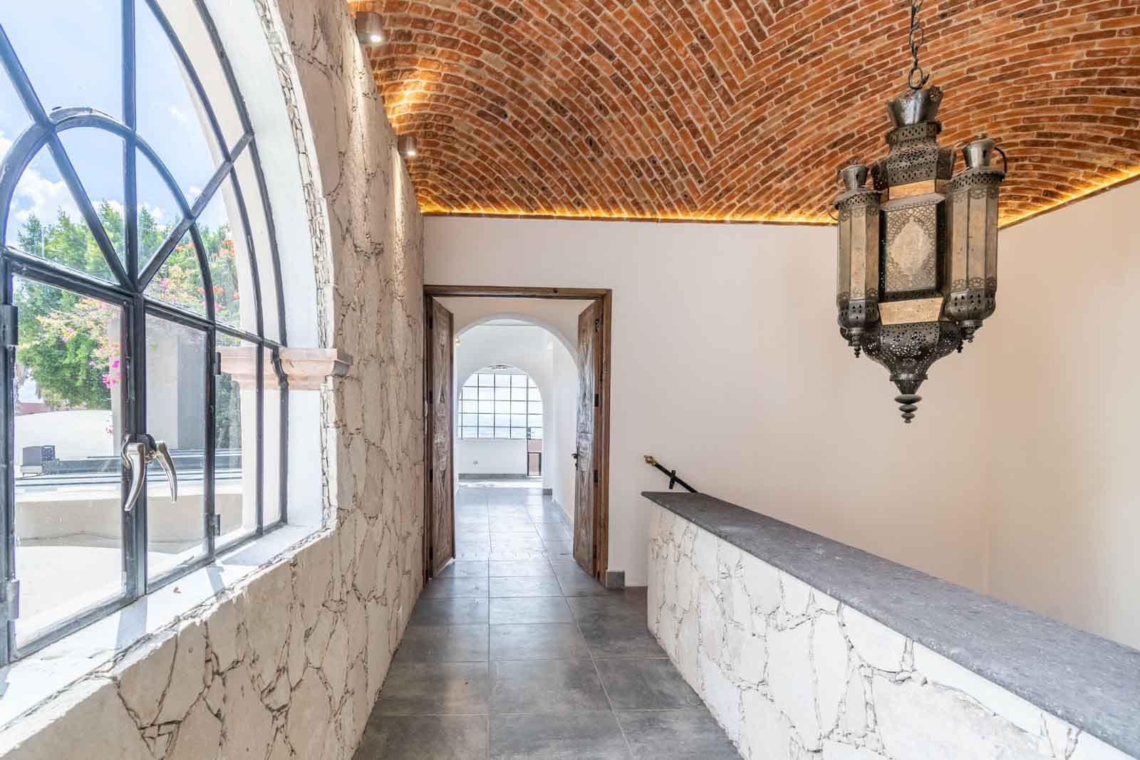 Casa Luz del Sol — Balcones, San Miguel de Allende — photo 20 — elegant corridor, soaring brick vaults, radiant light