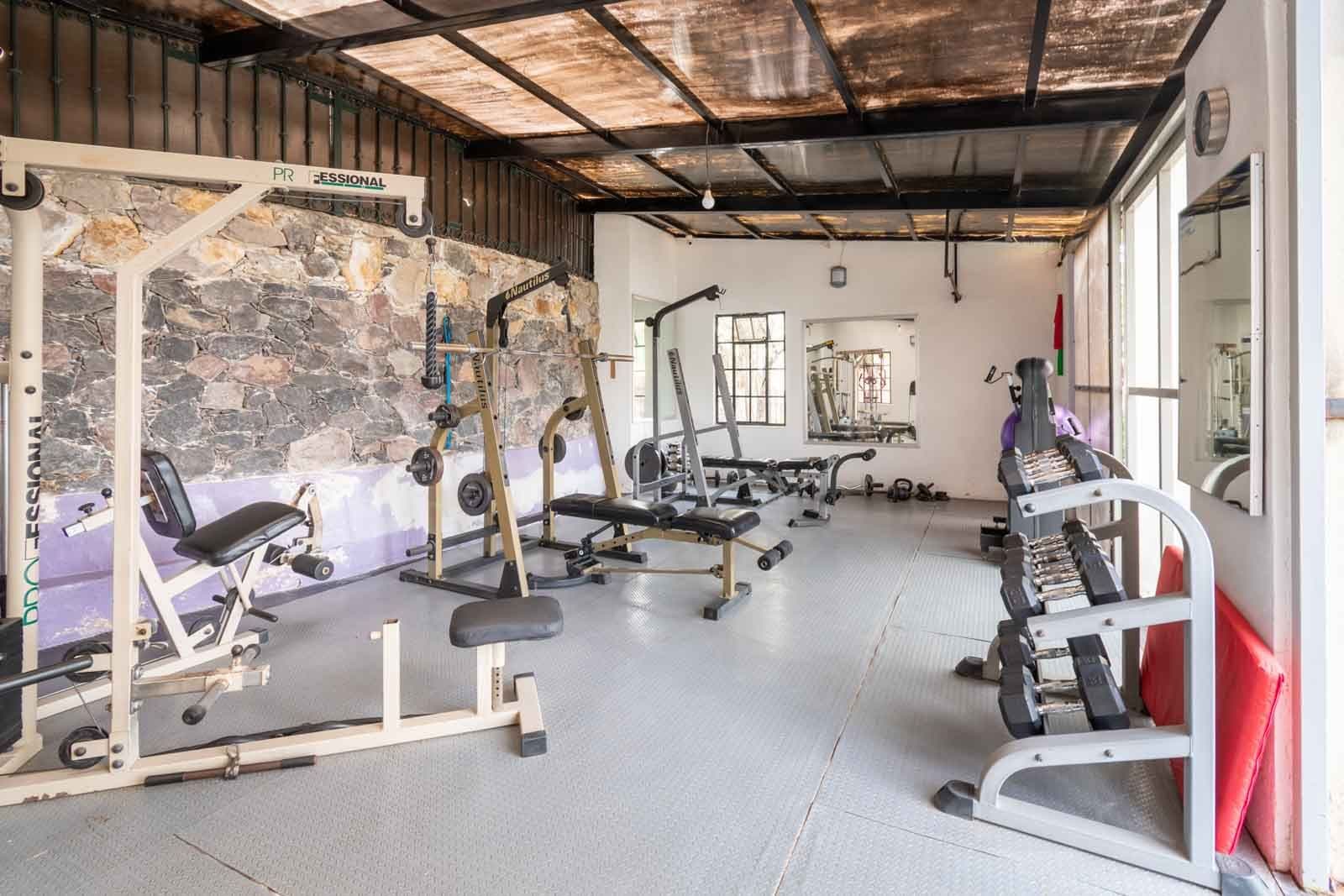 Santo Domingo Condo 3C — Centro, San Miguel de Allende — photo 20 — sophisticated fitness sanctuary with soaring ceilings