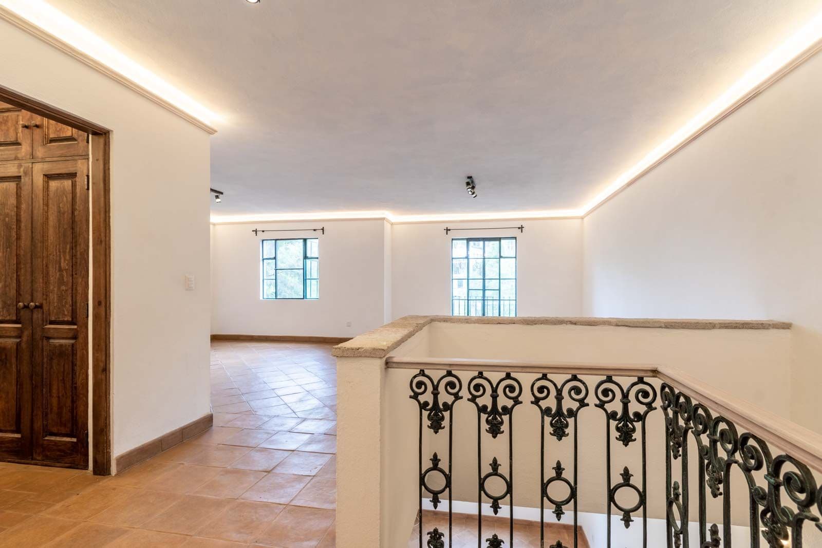 Santo Domingo Condo 3C — Centro, San Miguel de Allende — photo 3 — luminous gallery with ornate wrought-iron details