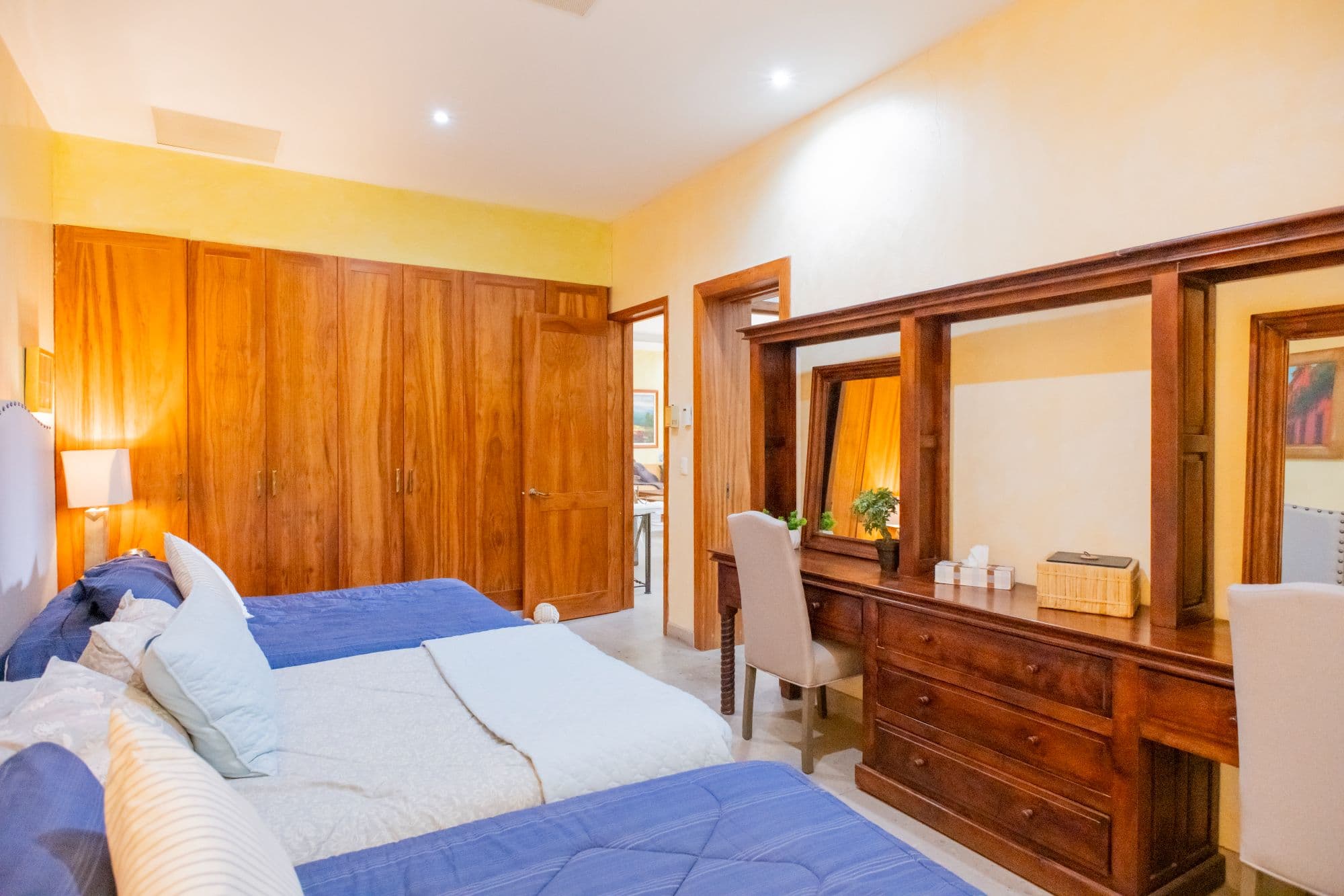 Casa Caracol — Caracol, San Miguel de Allende — photo 17 — sunlit master suite, refined wood elegance