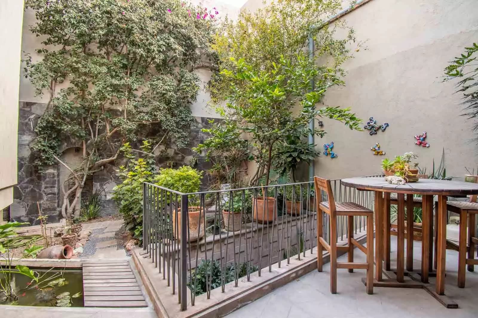 Casa Lumina — Ojo de Agua, San Miguel de Allende — photo 18 — serene courtyard oasis, mature gardens, alfresco dining