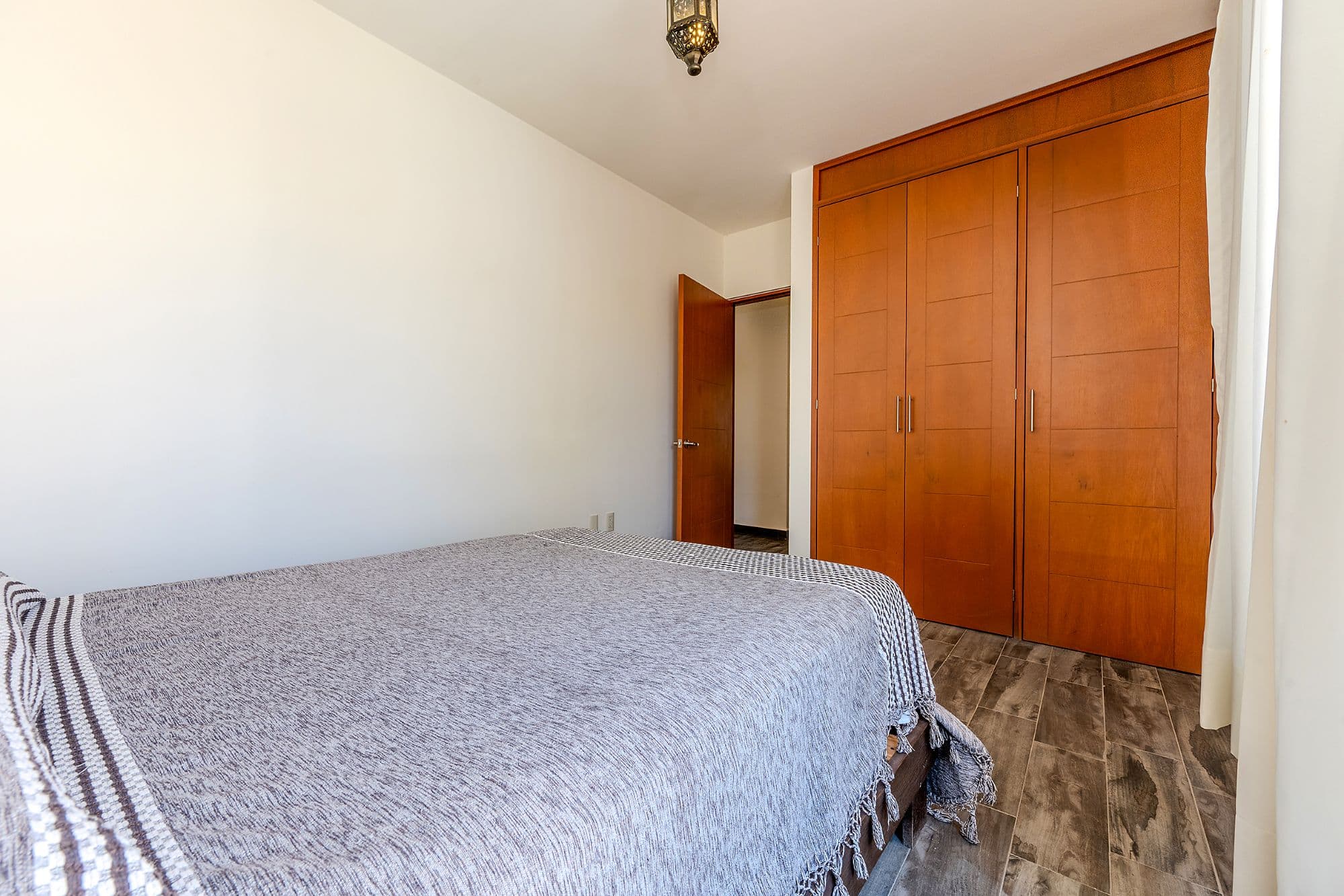 Casita Amanecer — Las Brisas, San Miguel de Allende — photo 10 — spacious bedroom with wood cabinetry