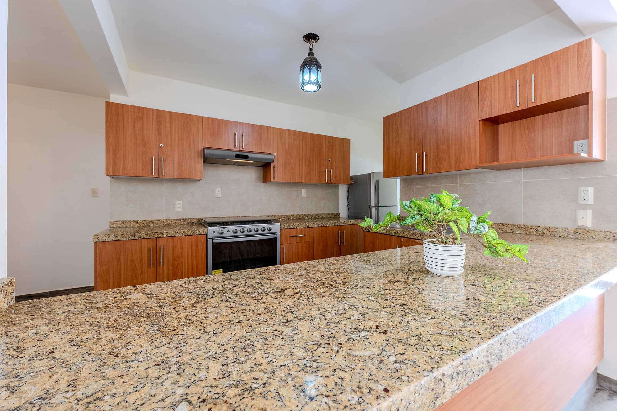 Casita Amanecer — Las Brisas, San Miguel de Allende — photo 5 — elegant granite kitchen, warm wood cabinetry