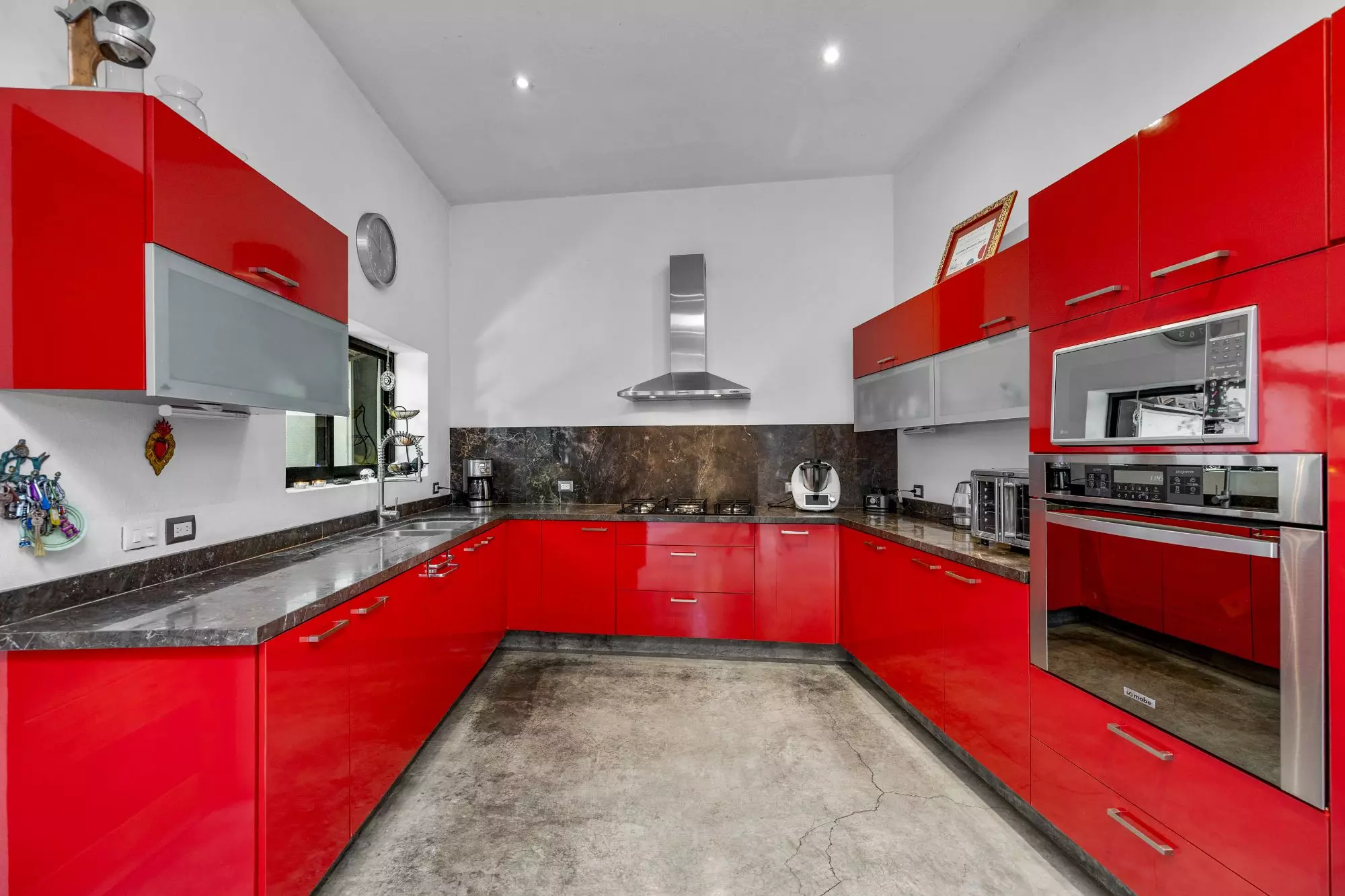 Casa Entre Arboles — San Antonio, San Miguel de Allende — photo 14 — contemporary red kitchen, sleek modern elegance