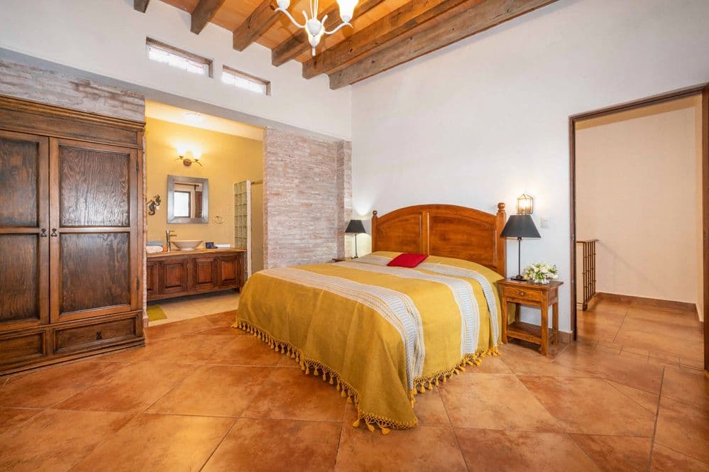 Casa Cactus — El Cortijo, San Miguel de Allende — photo 22 — rustic luxury master suite, soaring beams