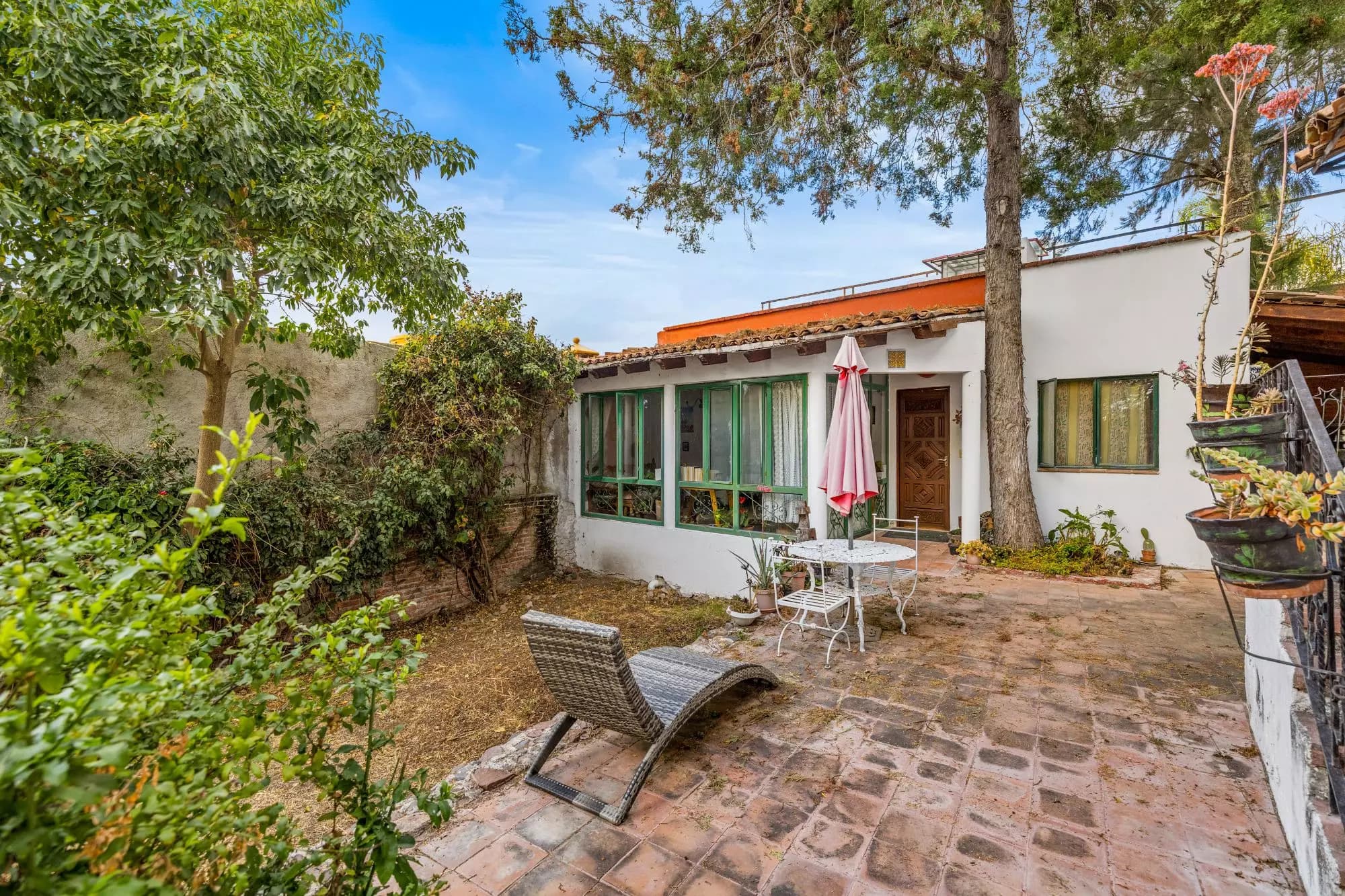 The Hidden House — Rinconada de Los Balcones, San Miguel de Allende — photo 16 — charming courtyard with mature gardens