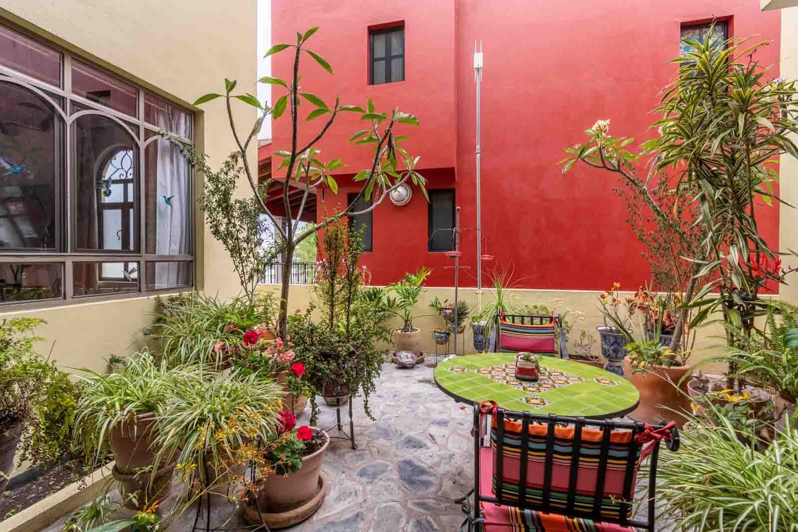 Casa Dar — El Capricho, San Miguel de Allende — photo 9 — vibrant colonial courtyard with lush gardens