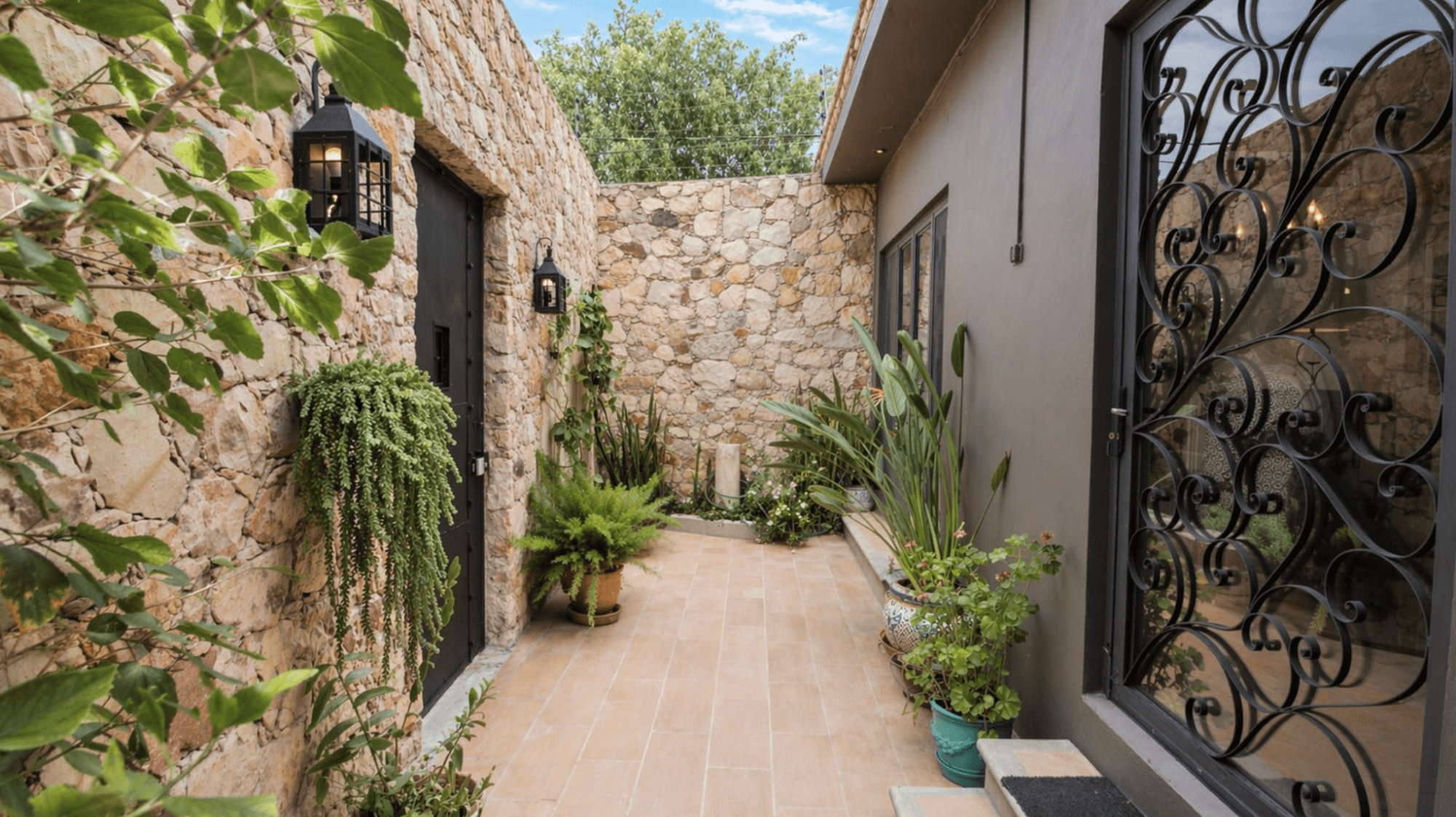 Casa Zen — El Obraje, San Miguel de Allende — photo 2 — charming stone courtyard with elegant ironwork