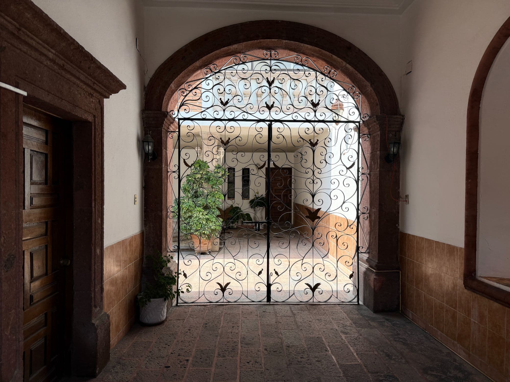 Casa Torres — Centro, San Miguel de Allende — photo 36 — elegant arched entry, ornate ironwork details