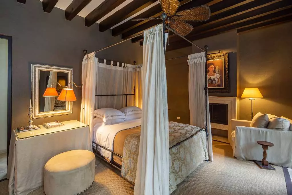 Casa Stream — Centro, San Miguel de Allende — photo 6 — elegant canopy bed, golden ambient lighting