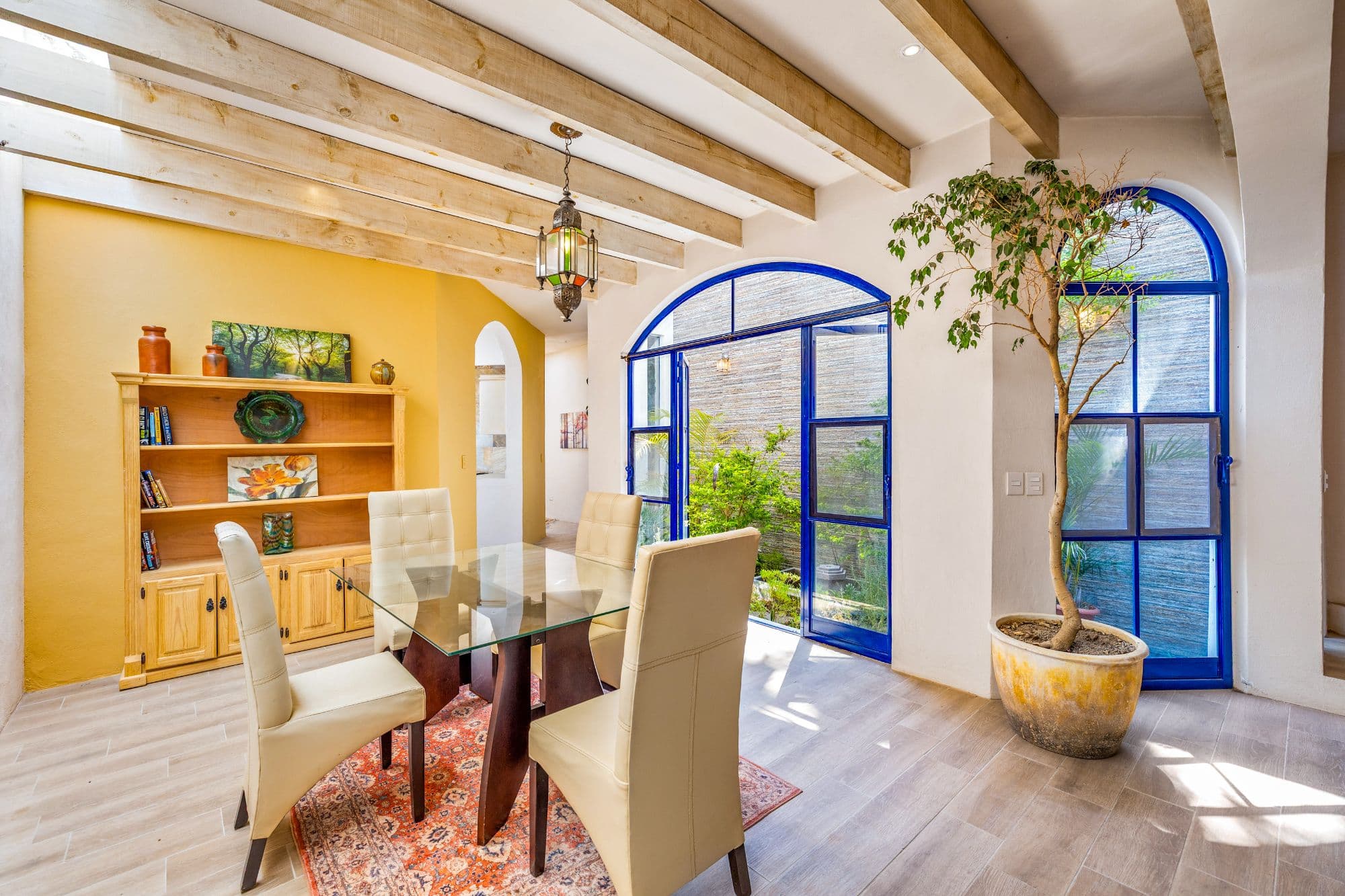 Casa del Agua — Atascadero (Arcos de San Miguel), San Miguel de Allende — photo 7 — radiant dining room, cobalt-framed gardens