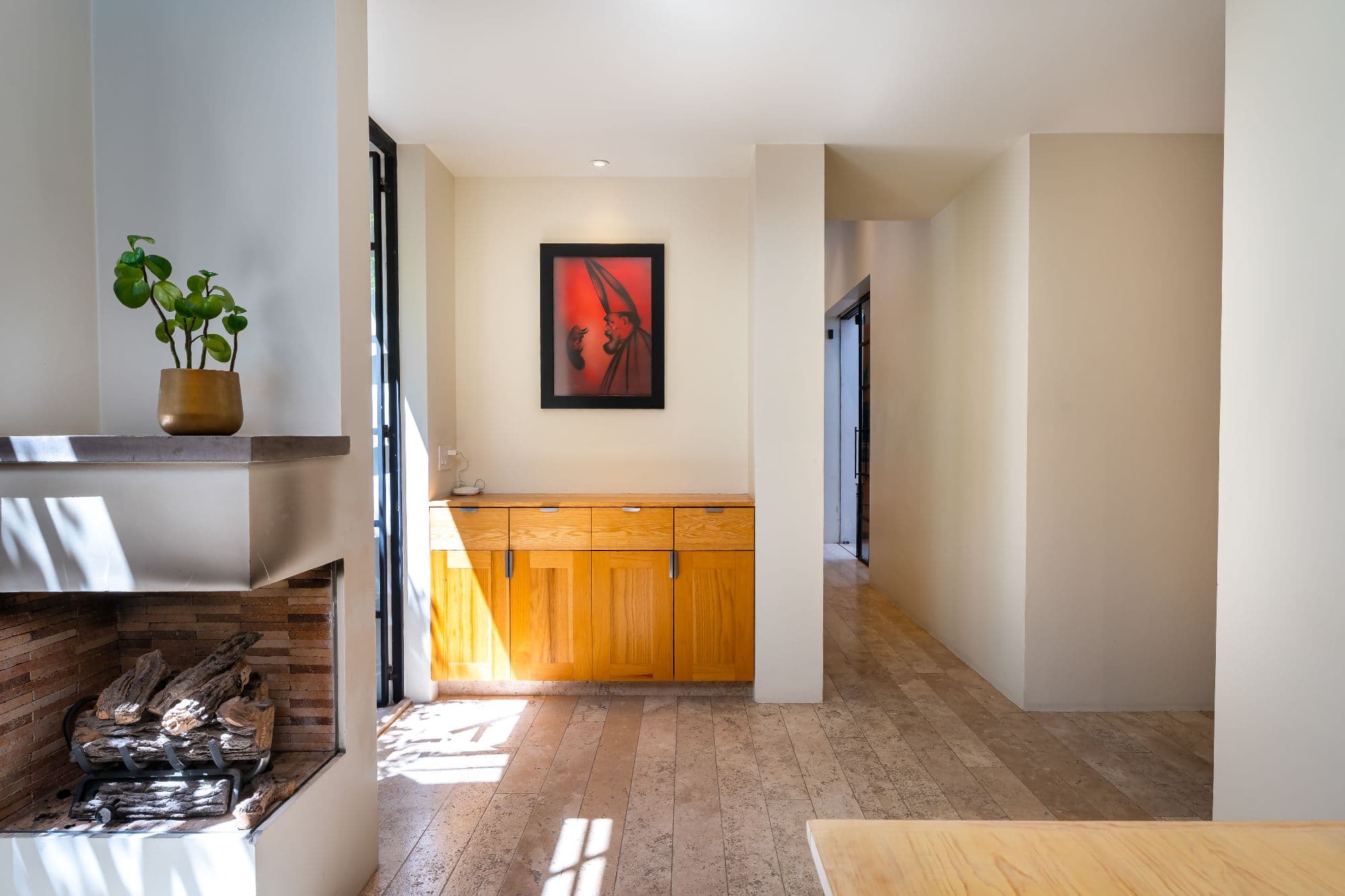 Casa Organza — Centro, San Miguel de Allende — photo 17 — sunlit foyer, warm wood cabinetry