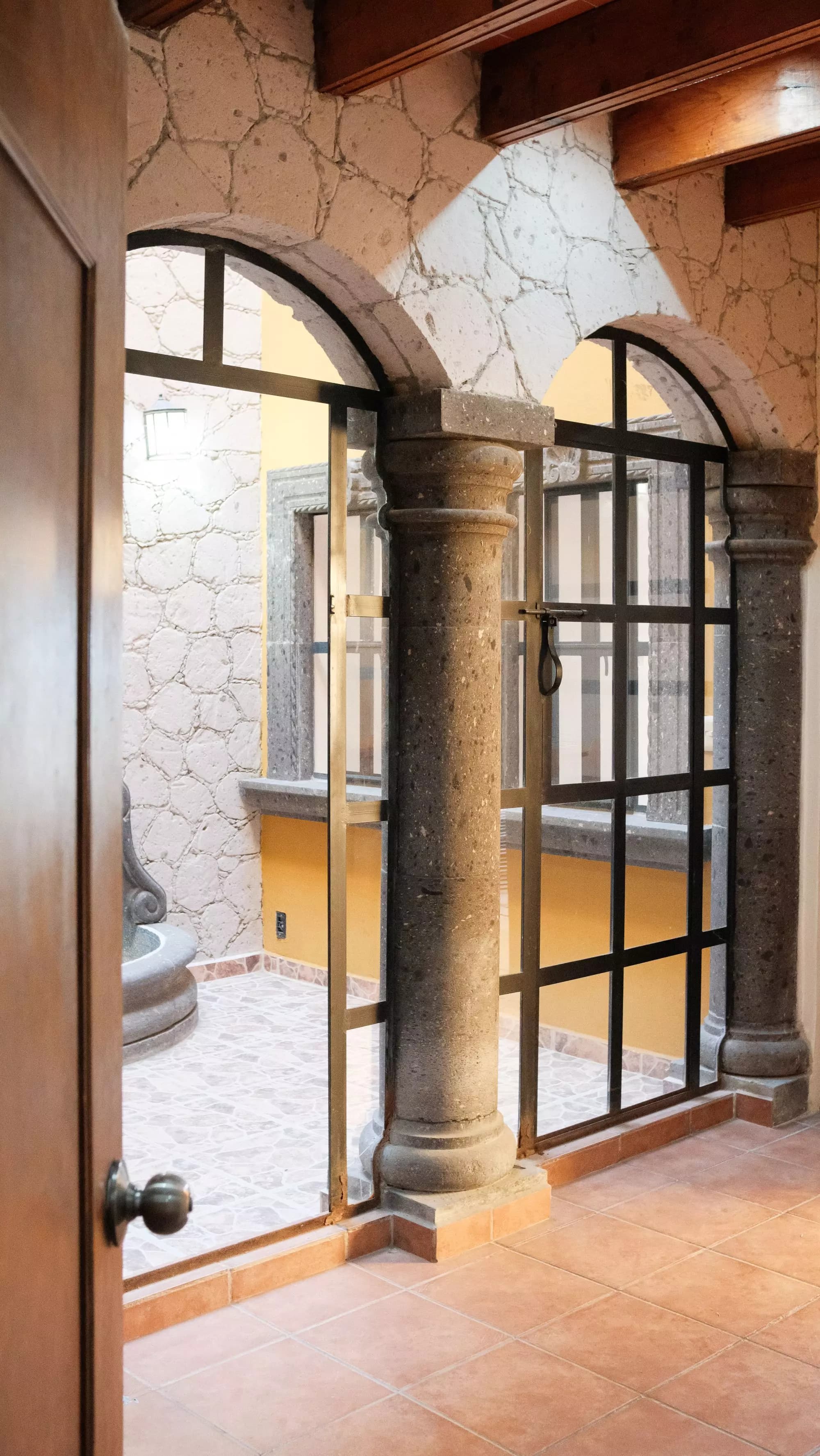 Casa La Lomita — La Lomita, San Miguel de Allende — photo 5 — elegant arched passage, warm golden light