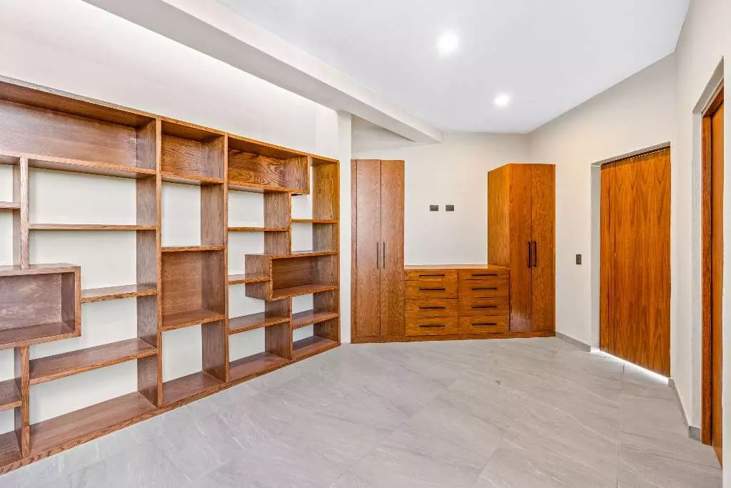Casa De La Vista — Residencial Malanquin la Mesa, San Miguel de Allende — photo 14 — sophisticated walk-in closet with custom woodwork