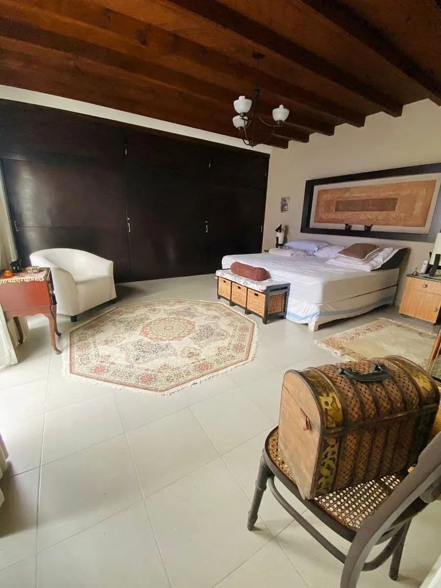 Casa Magenta — El Paraiso, San Miguel de Allende — photo 14 — spacious master suite, rustic beams, elegant ambiance
