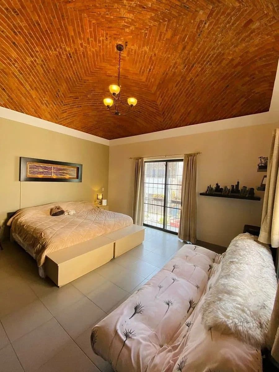 Casa Magenta — El Paraiso, San Miguel de Allende — photo 18 — warm masterbed with artisan wood ceiling