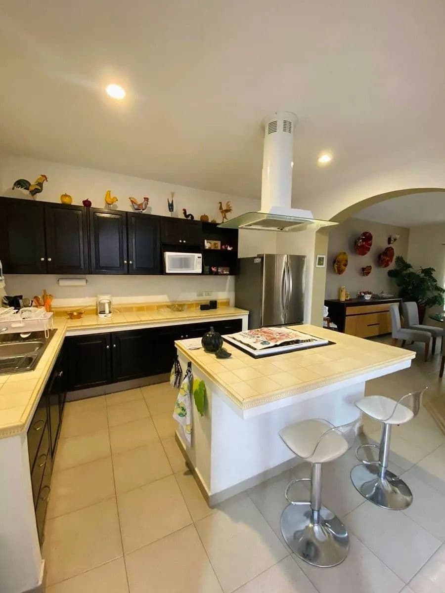 Casa Magenta — El Paraiso, San Miguel de Allende — photo 21 — modern kitchen with elegant island seating