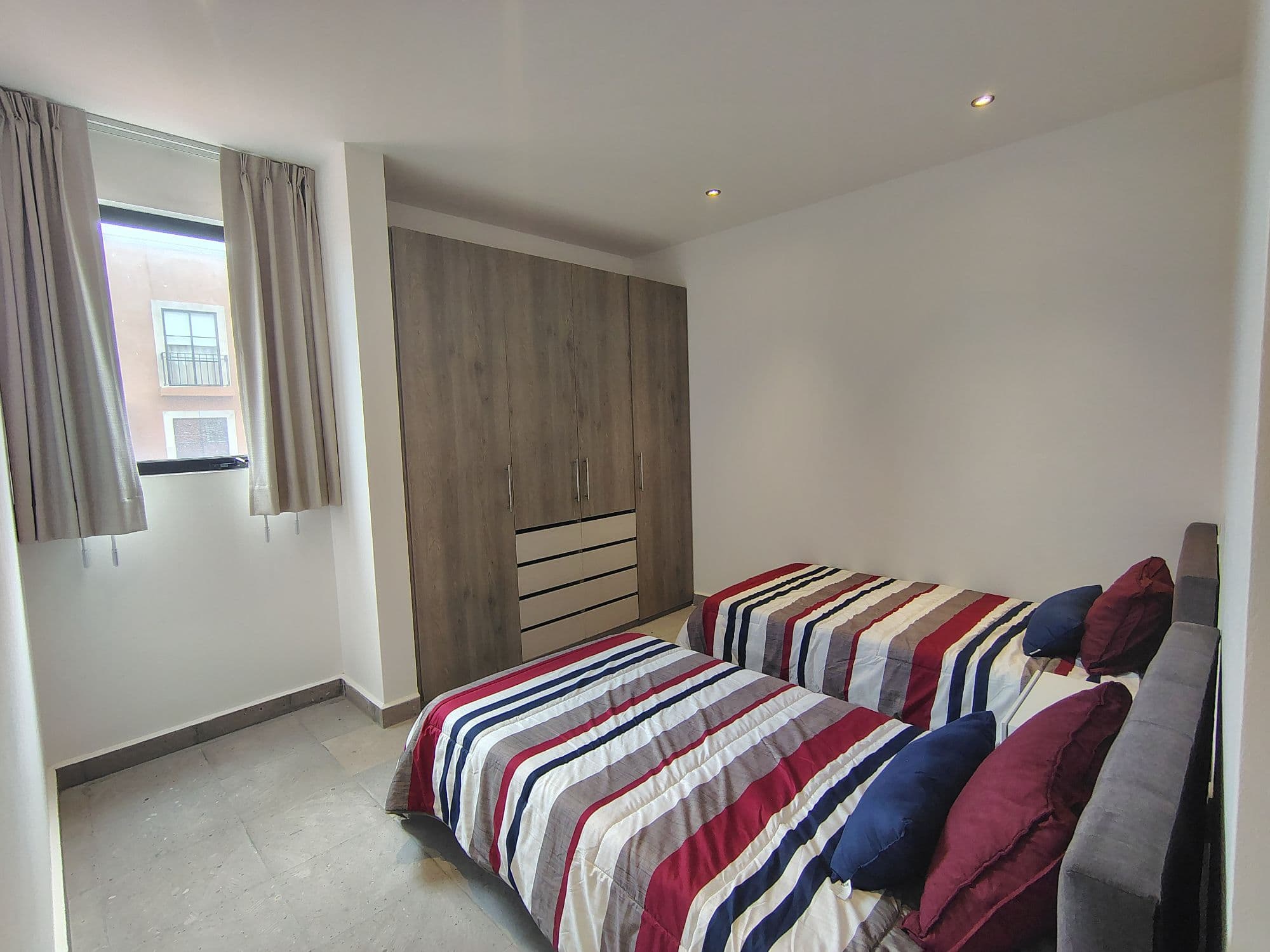 NUBE A 101 SAN FRANCISCO — San Miguel de Allende Centro, San Miguel de Allende — photo 12 — serene dual bedroom with ample storage