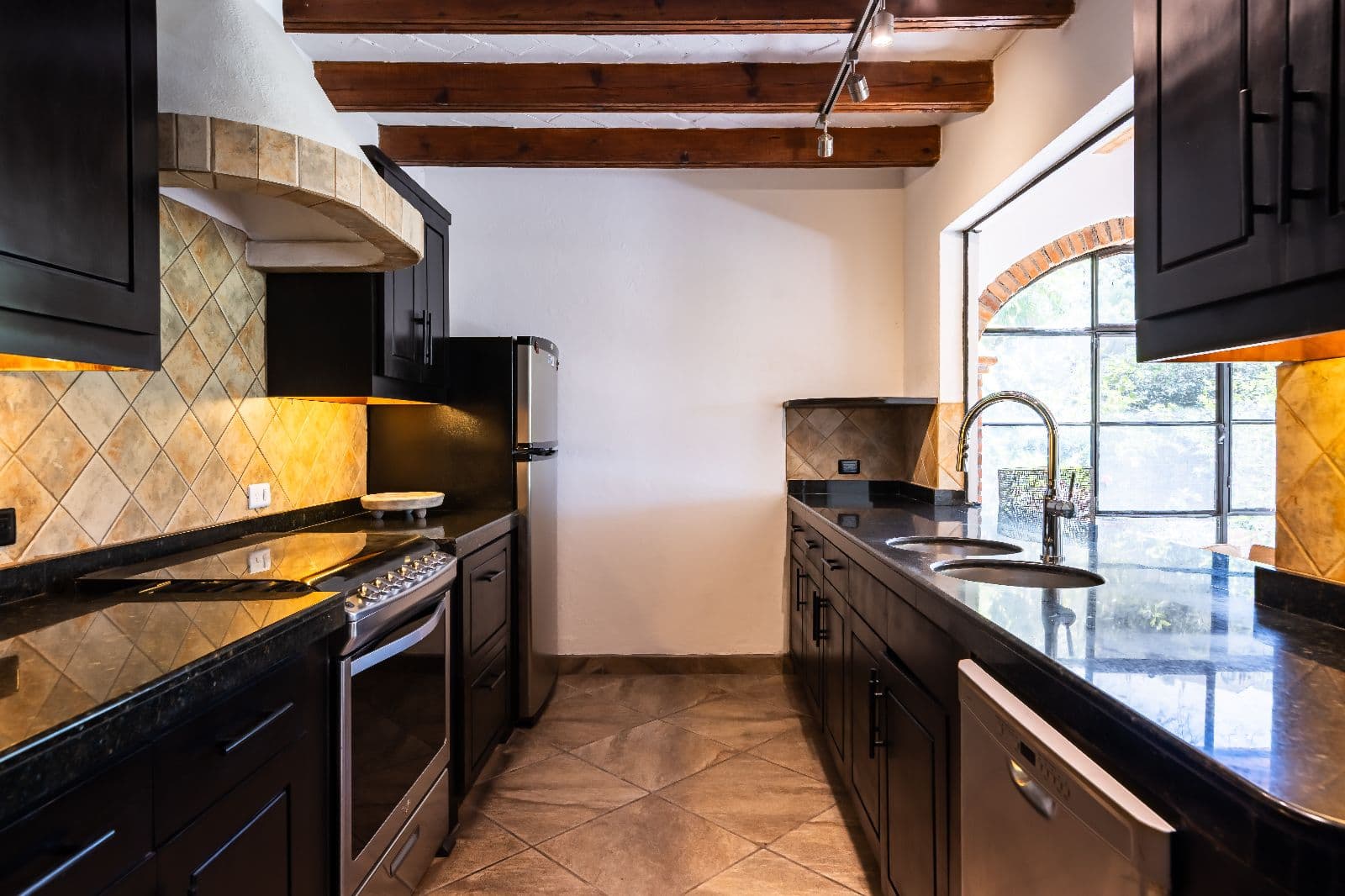 Casa Shangri-La — Centro, San Miguel de Allende — photo 9 — elegant galley kitchen, golden light, architectural charm