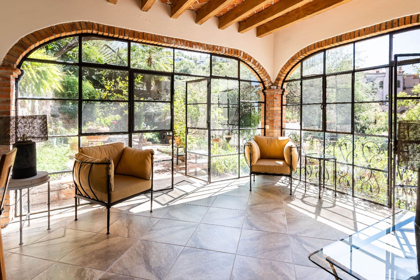Casa Shangri-La — Centro, San Miguel de Allende — photo 8 — sun-drenched conservatory with arched brick details
