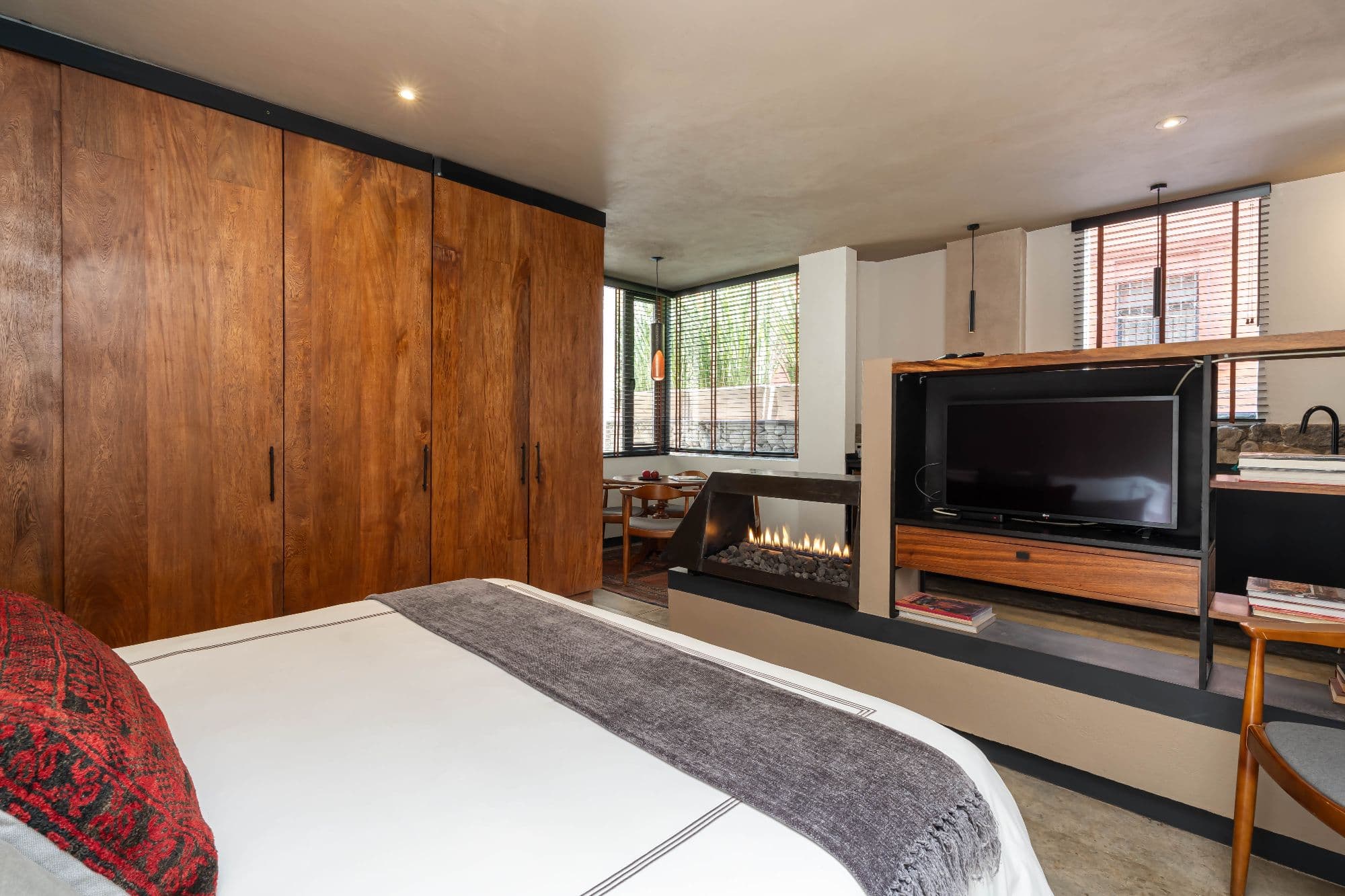 The Lofts — Centro, San Miguel de Allende — photo 15 — contemporary luxury master suite with fireplace