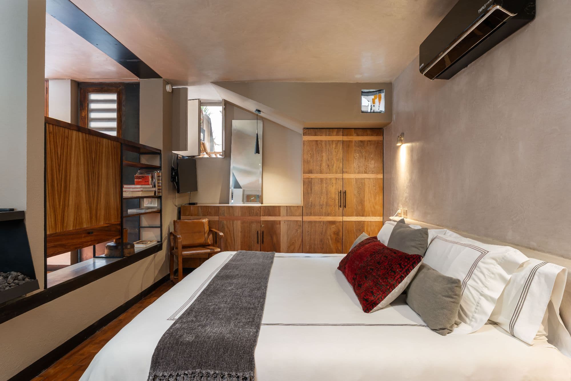 The Lofts — Centro, San Miguel de Allende — photo 7 — sophisticated master suite, warm wood elegance