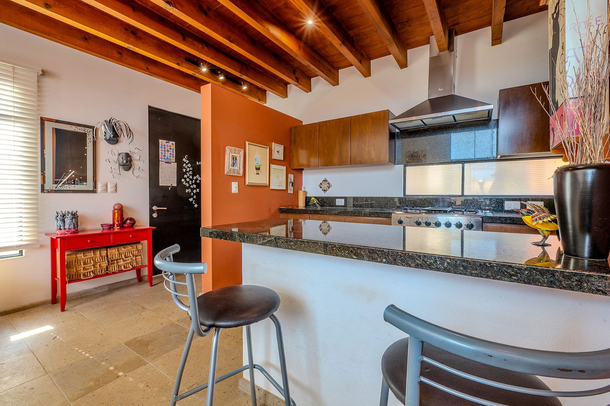 Casa Adrian — San Antonio, San Miguel de Allende — photo 8 — vibrant open-concept kitchen with character beams