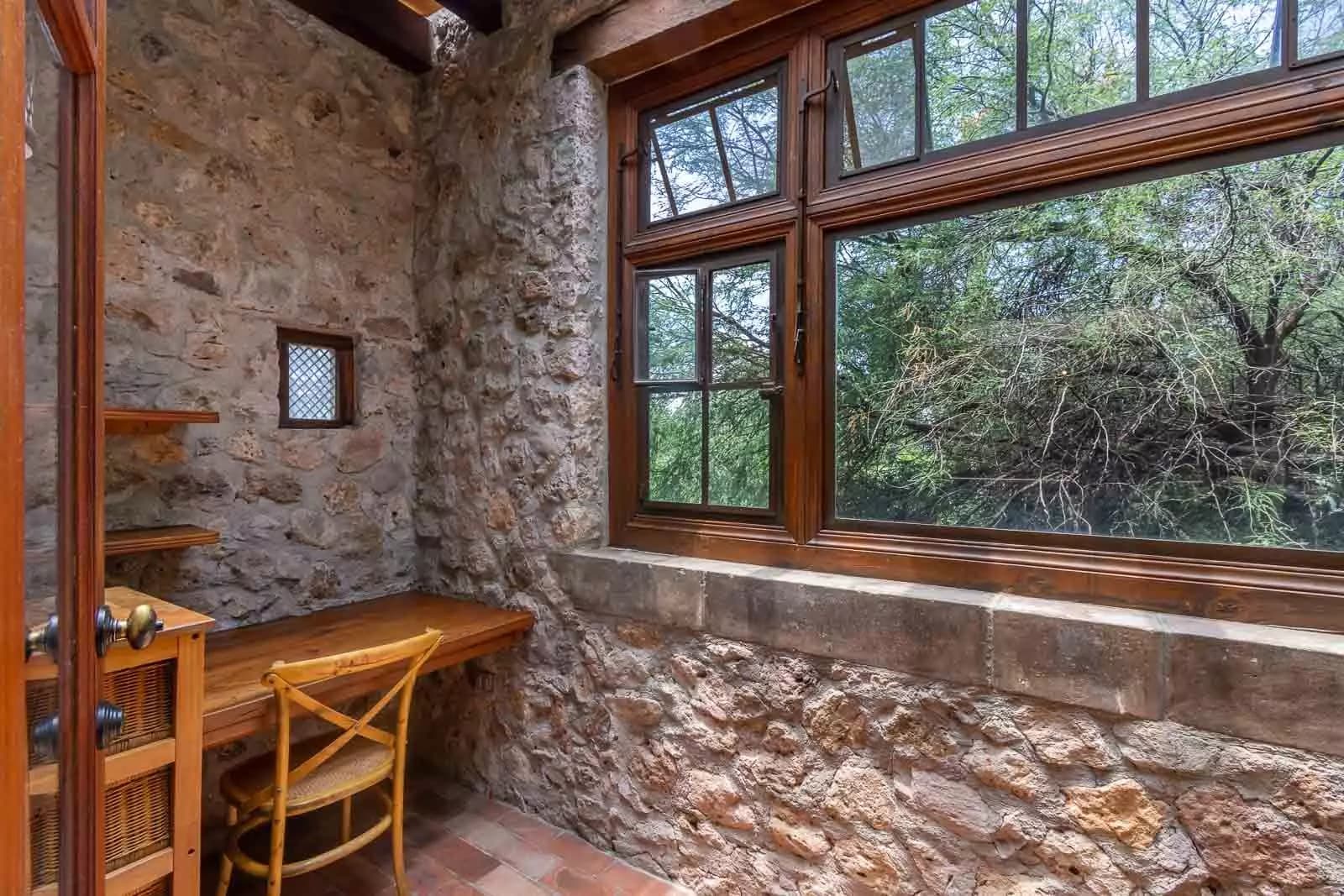 Casa la Perla — Ojo de Agua, San Miguel de Allende — photo 22 — rustic stone study, luminous garden views