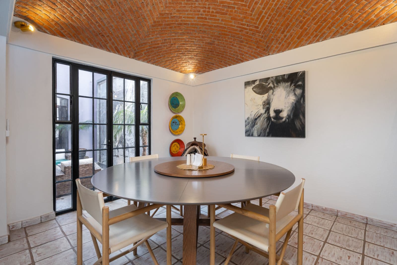 Casa Bruno — Guadalupe, San Miguel de Allende — photo 4 — elegant round dining with exposed brick ceiling