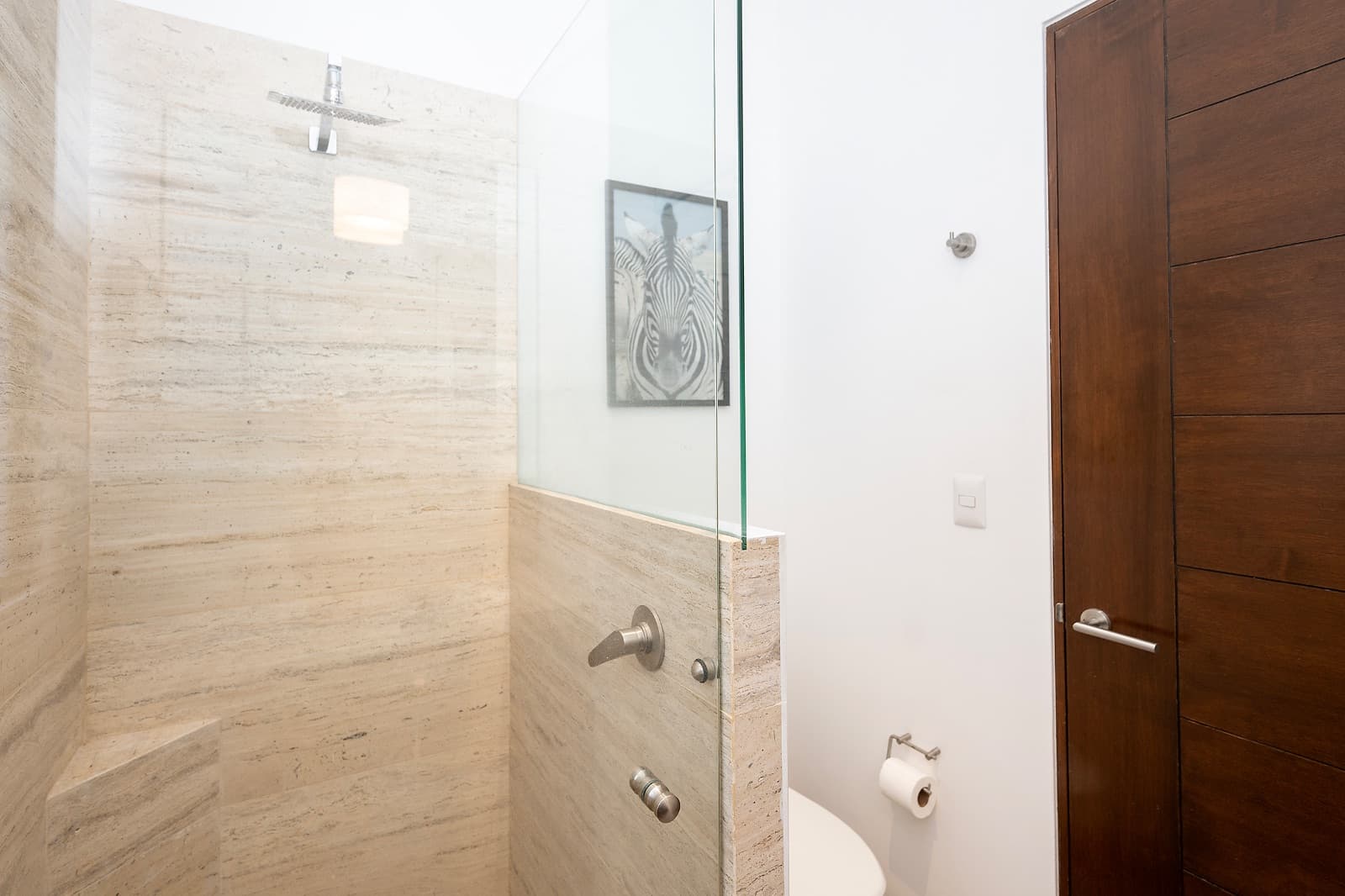 Modern Ground-Level Condo Near Centro — San Antonio, San Miguel de Allende — photo 19 — spa-like shower with travertine elegance