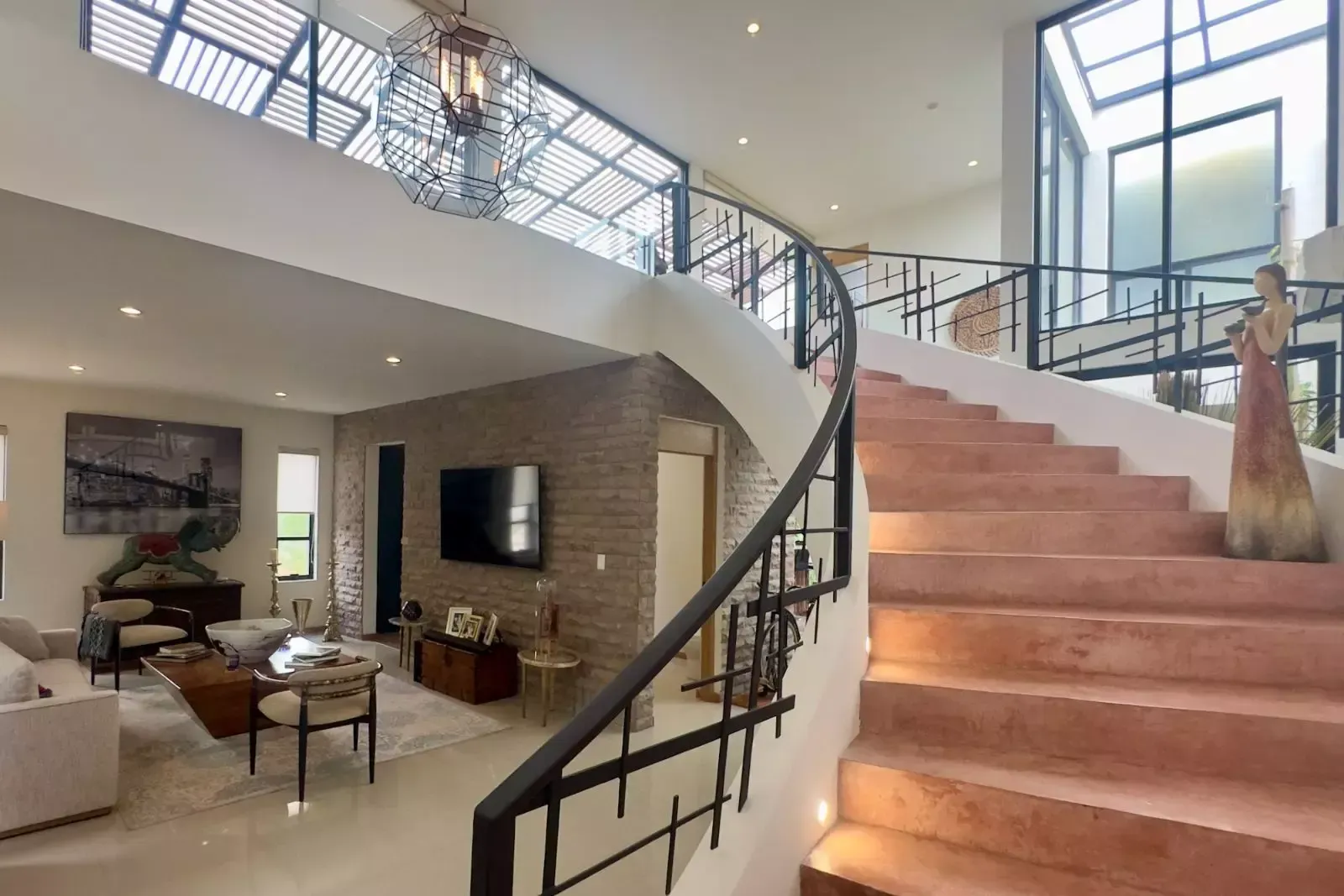CASA CORDOBA — Residencial Malanquin la Mesa, San Miguel de Allende — photo 3 — dramatic spiral staircase, soaring natural light