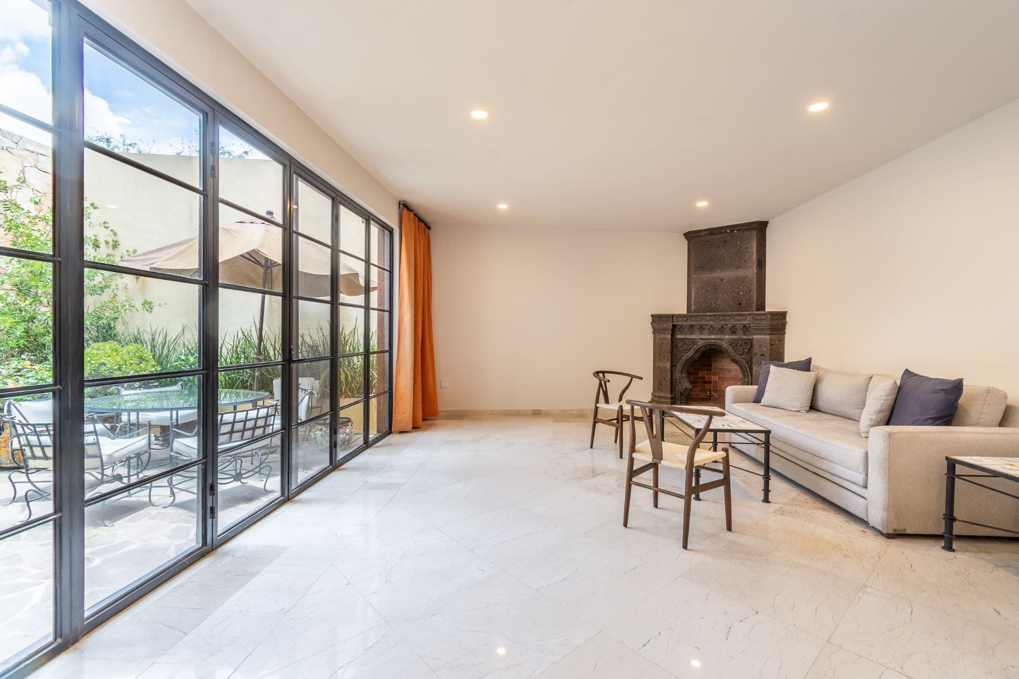 CASA PACO — San Antonio, San Miguel de Allende — photo 3 — luminous salon with fireplace charm