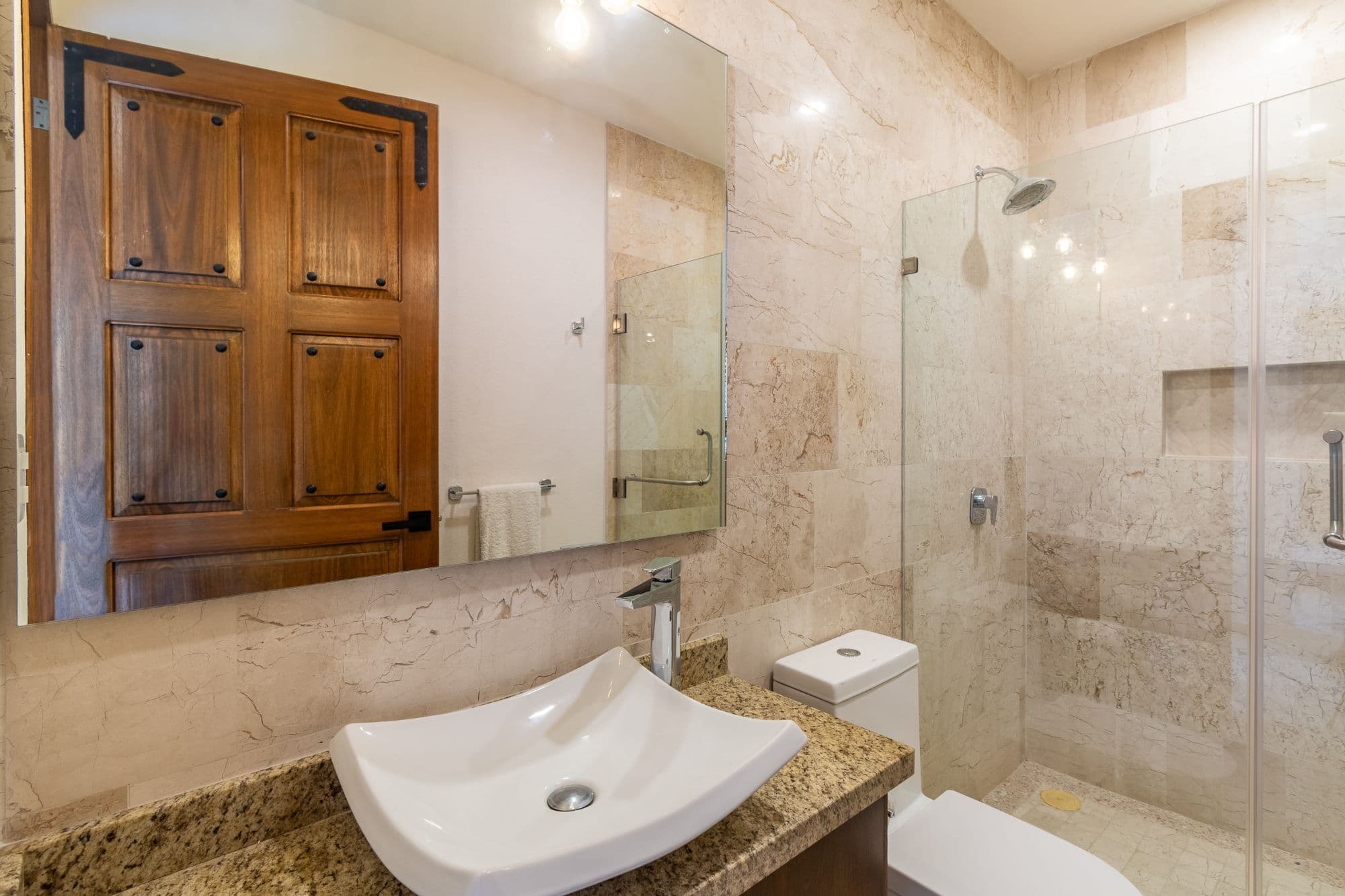 CASA PACO — San Antonio, San Miguel de Allende — photo 10 — spa-inspired master bath with travertine elegance