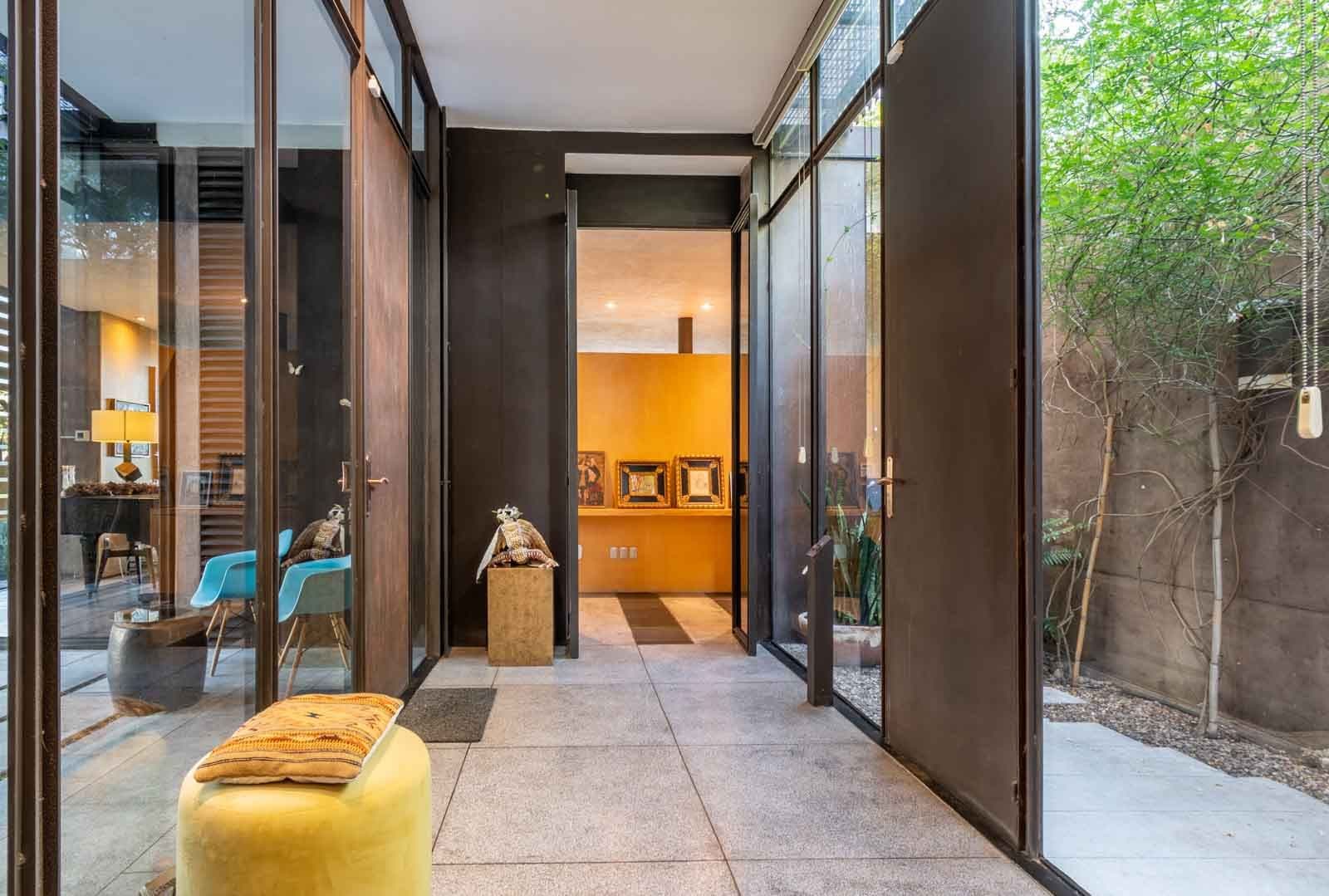 Casa Montolea — Los Senderos, Valle de los, San Miguel de Allende — photo 4 — contemporary courtyard with warm amber accents