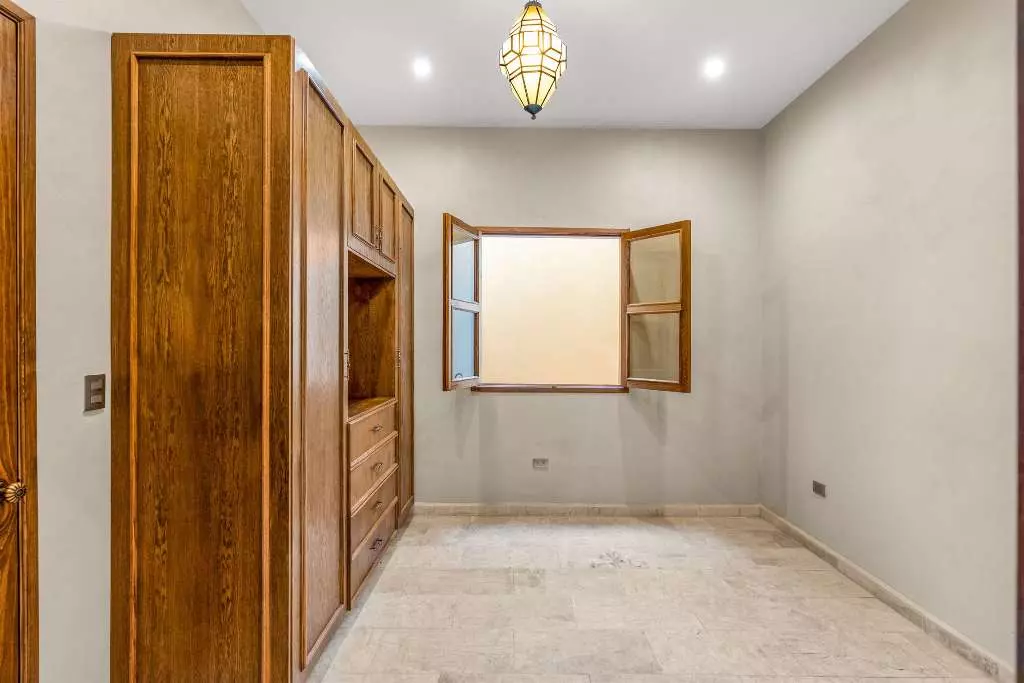 Casa Del Farolito — Guadalupe, San Miguel de Allende — photo 15 — elegant dressing room, warm wood cabinetry