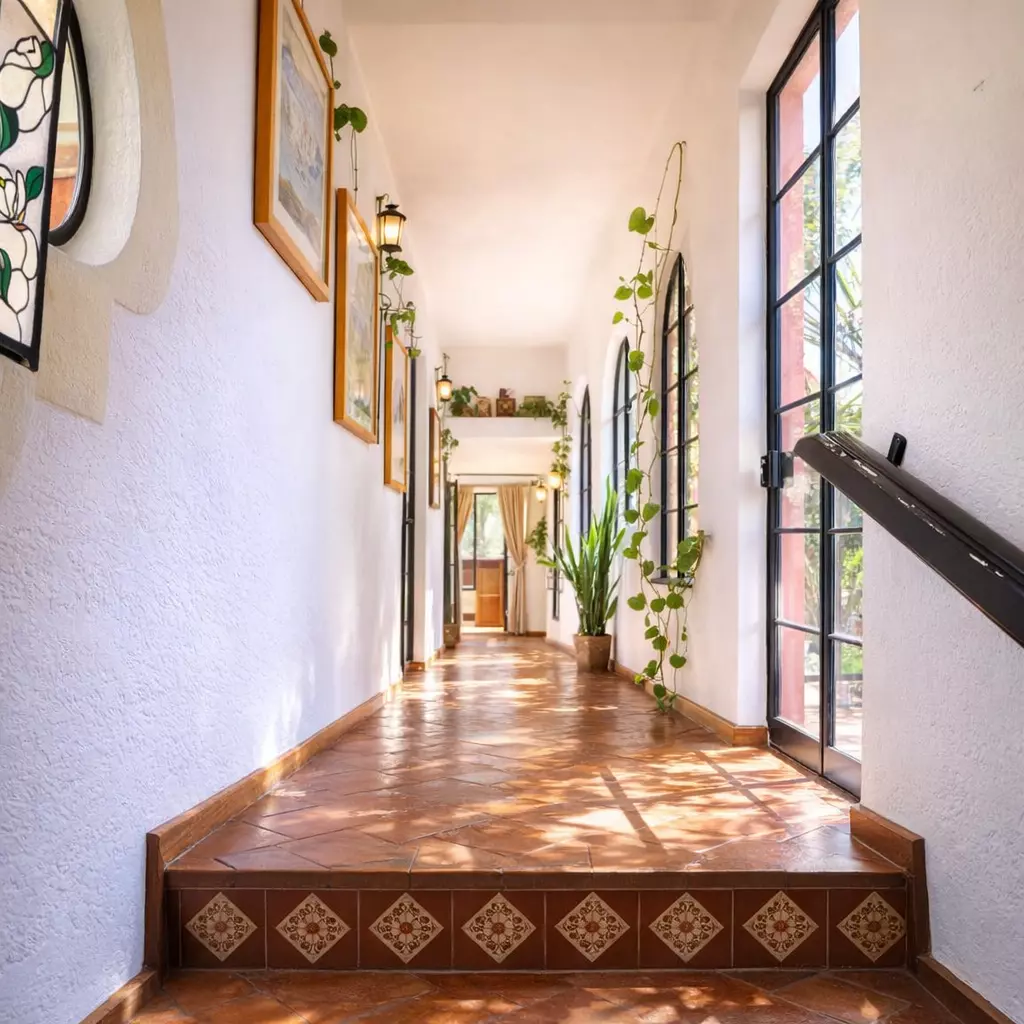 Casa Vergel — San Antonio, San Miguel de Allende — photo 9 — sunlit colonial corridor, verdant elegance